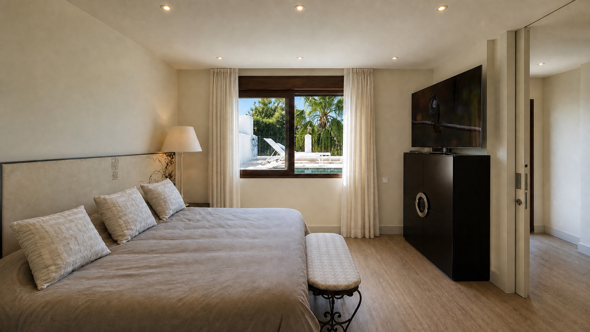 Bright bedroom with pool view at the La Isla penthouse