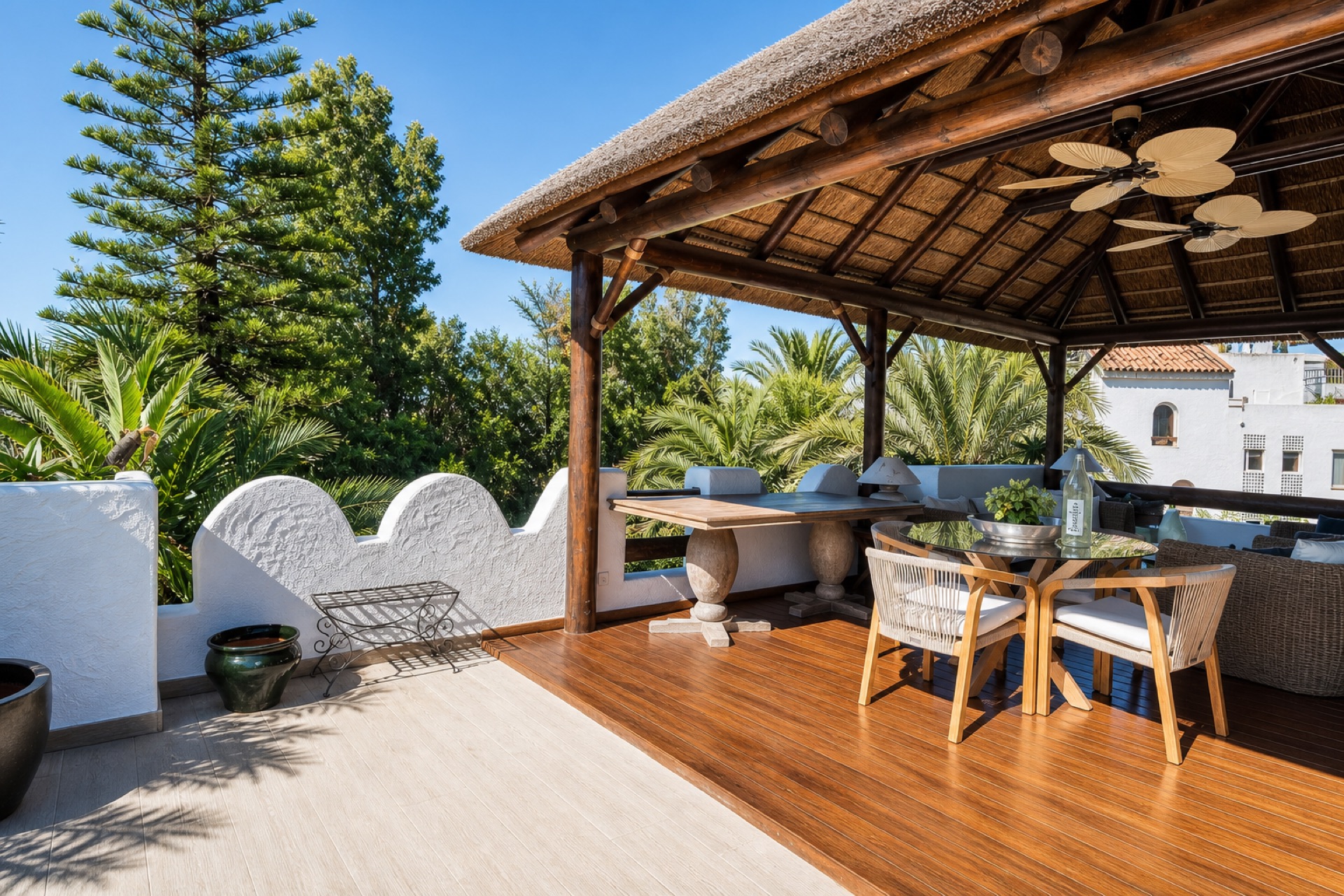 Covered terrace with dining and lounge at the La Isla penthouse