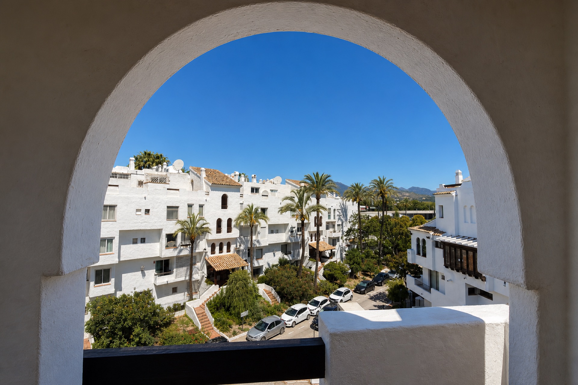 Community view through arch at the La Isla penthouse