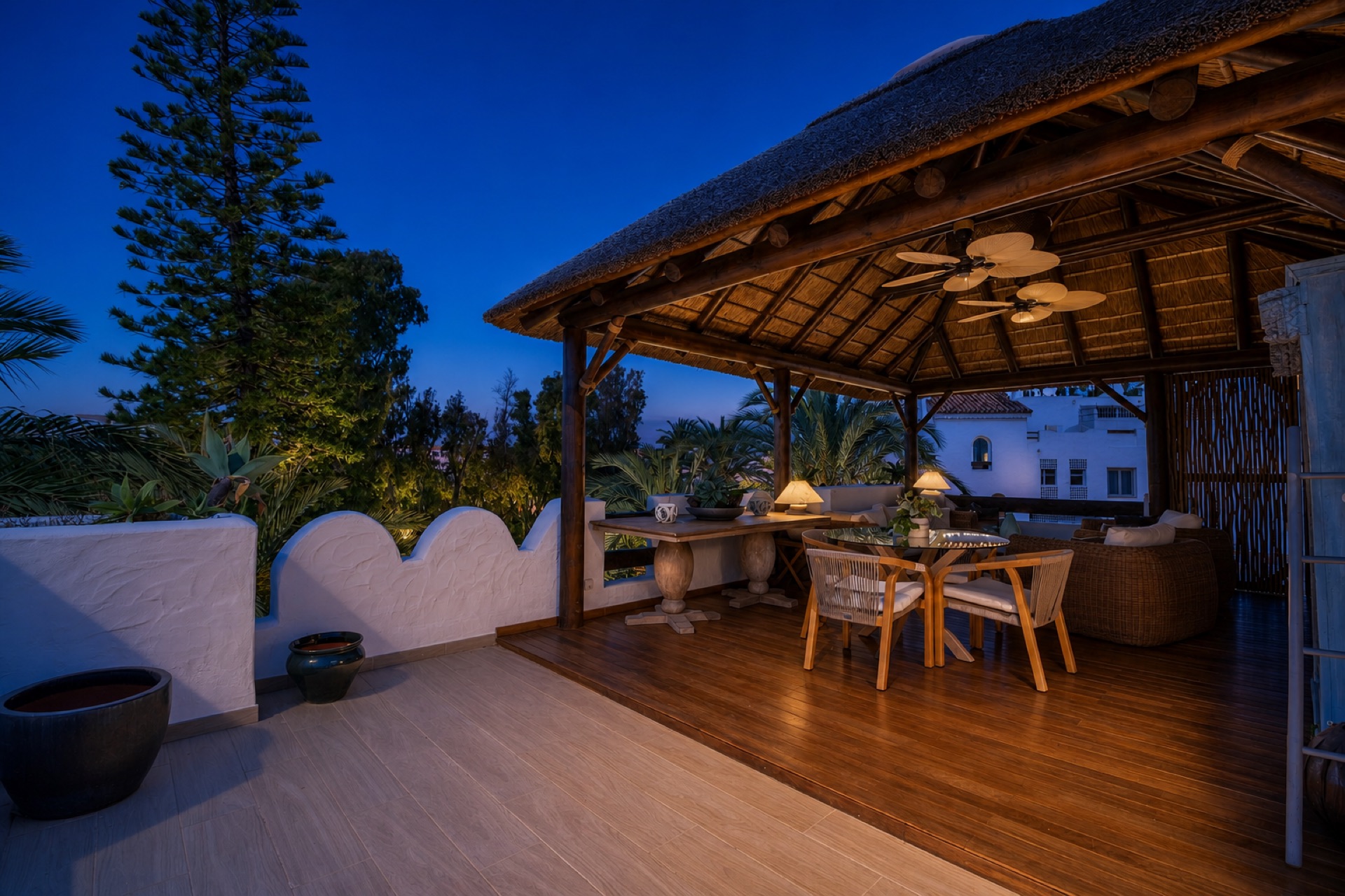 Covered terrace with dining and lounge at the La Isla penthouse