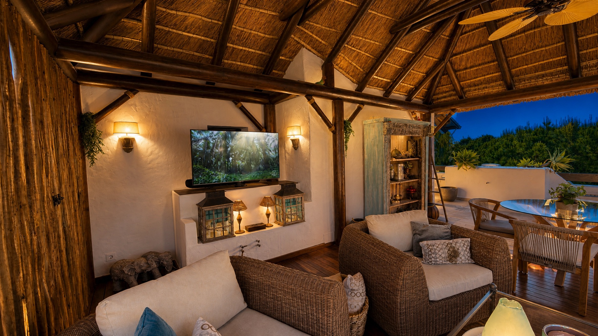 Cozy covered terrace with rattan furniture at the La Isla penthouse