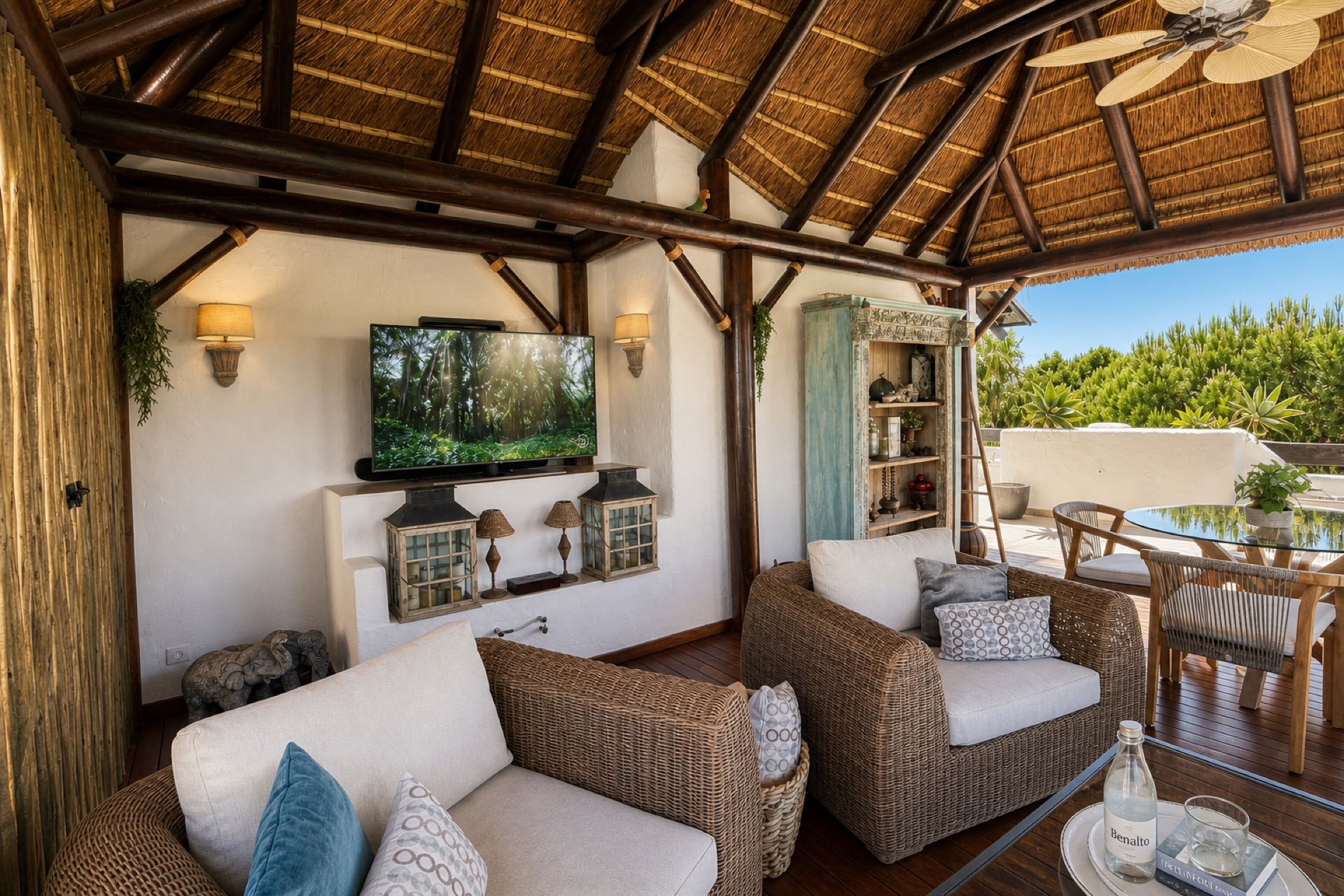 Covered terrace with rattan seating at the La Isla penthouse